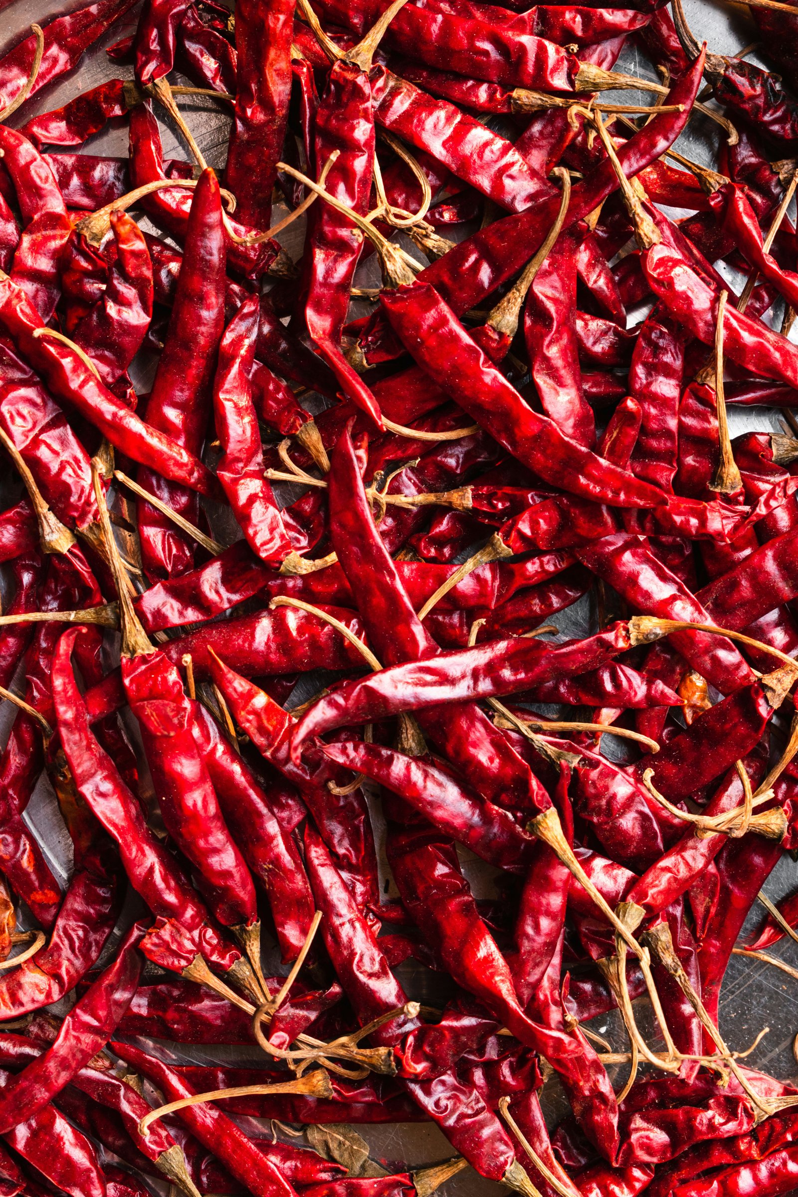 Dried red chillies spread on ground